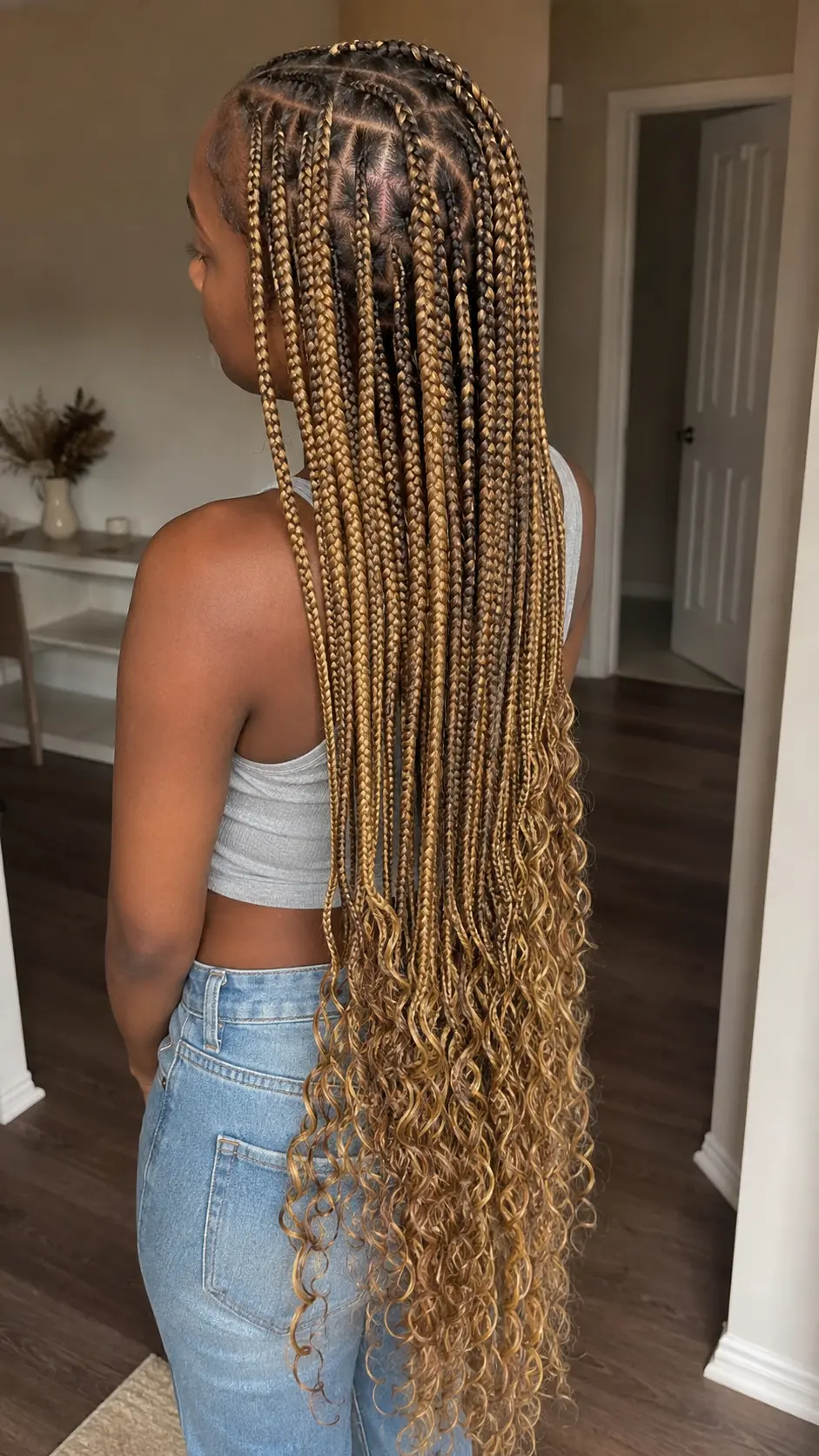 Honey-blonde Jada Wayda braids with curled ends