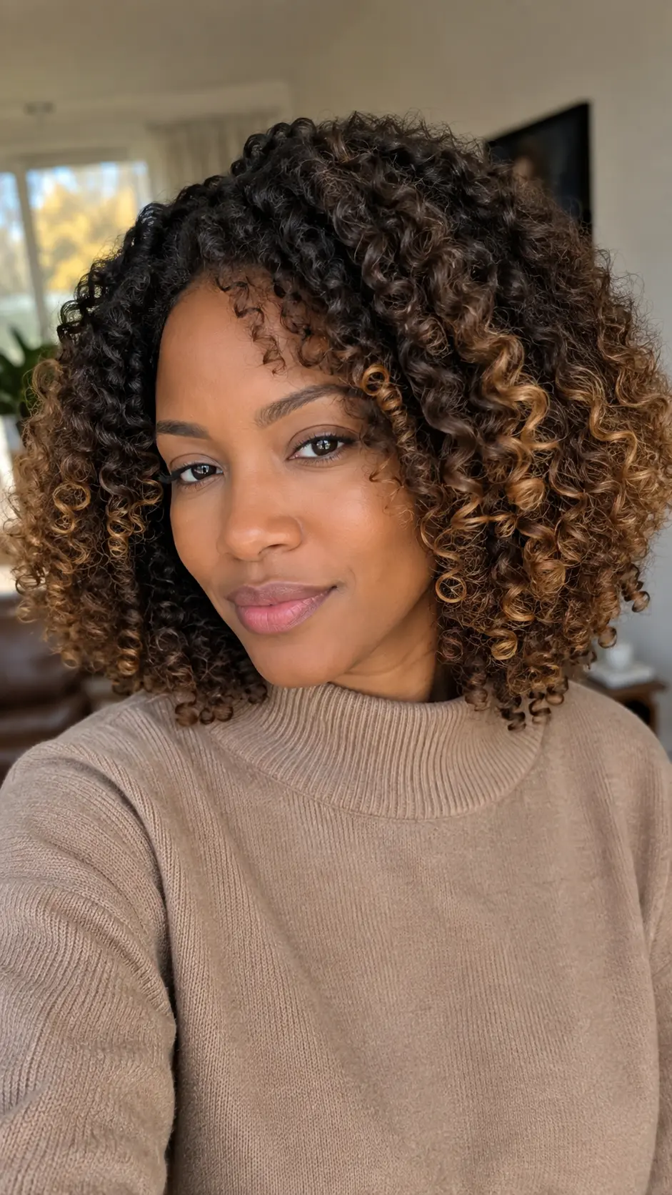 Dark brown curly hair with warm blonde tips