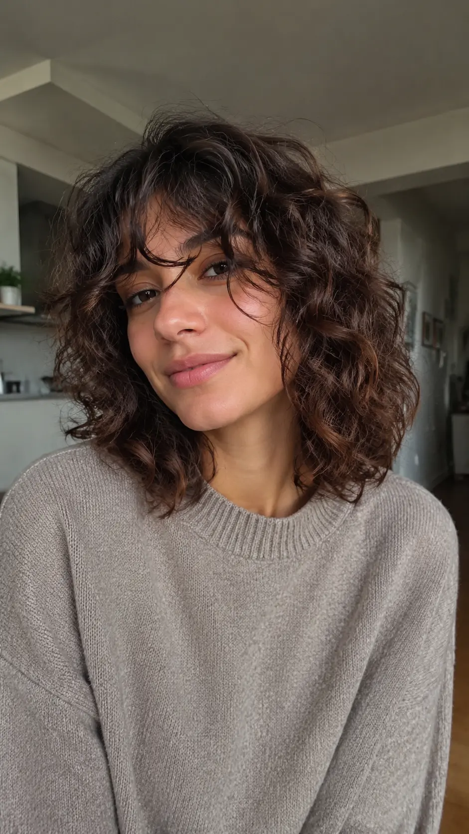 Tousled beachy shoulder length curly lob
