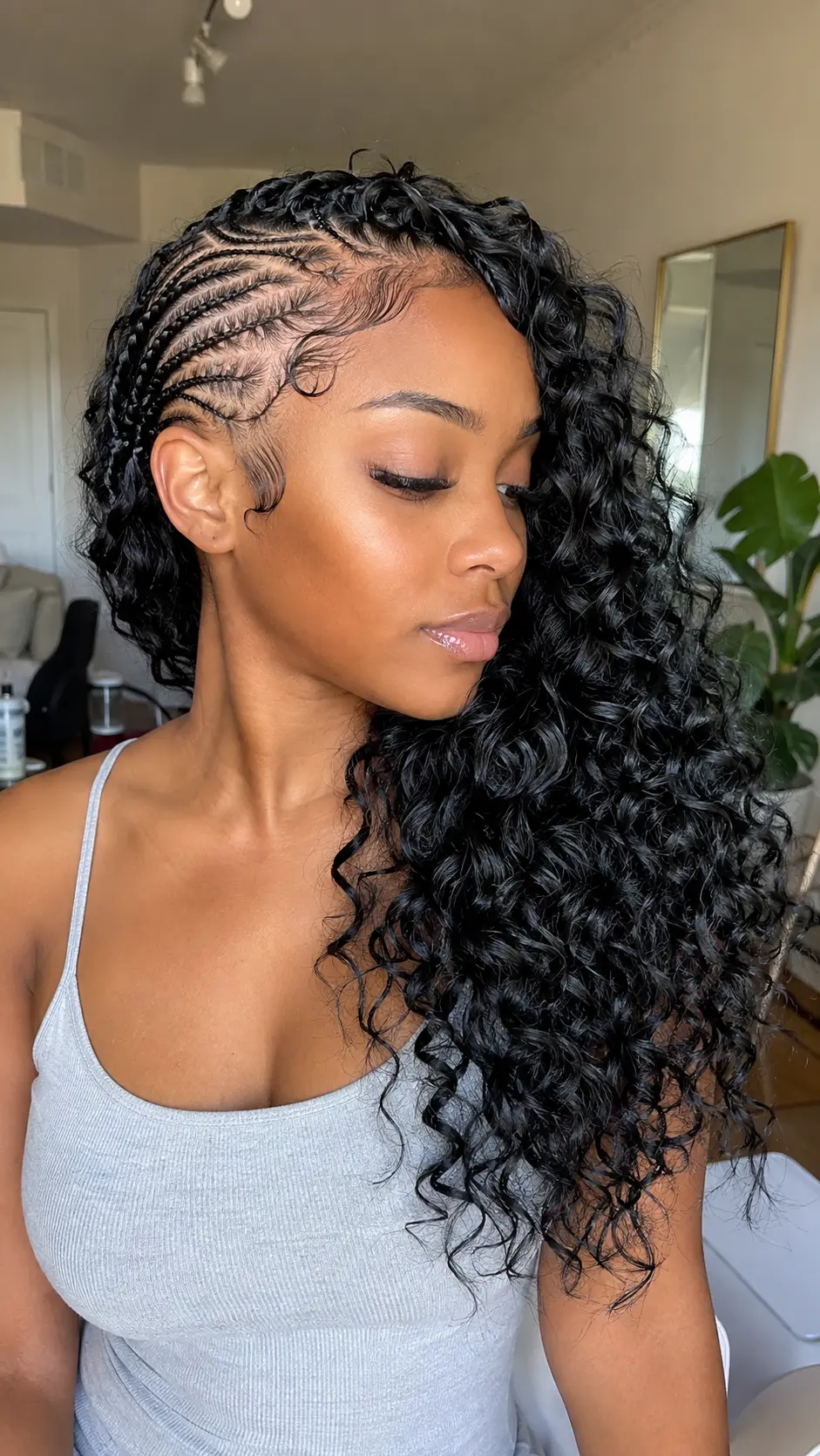 Side-swept Jada Wayda curls with curved cornrows
