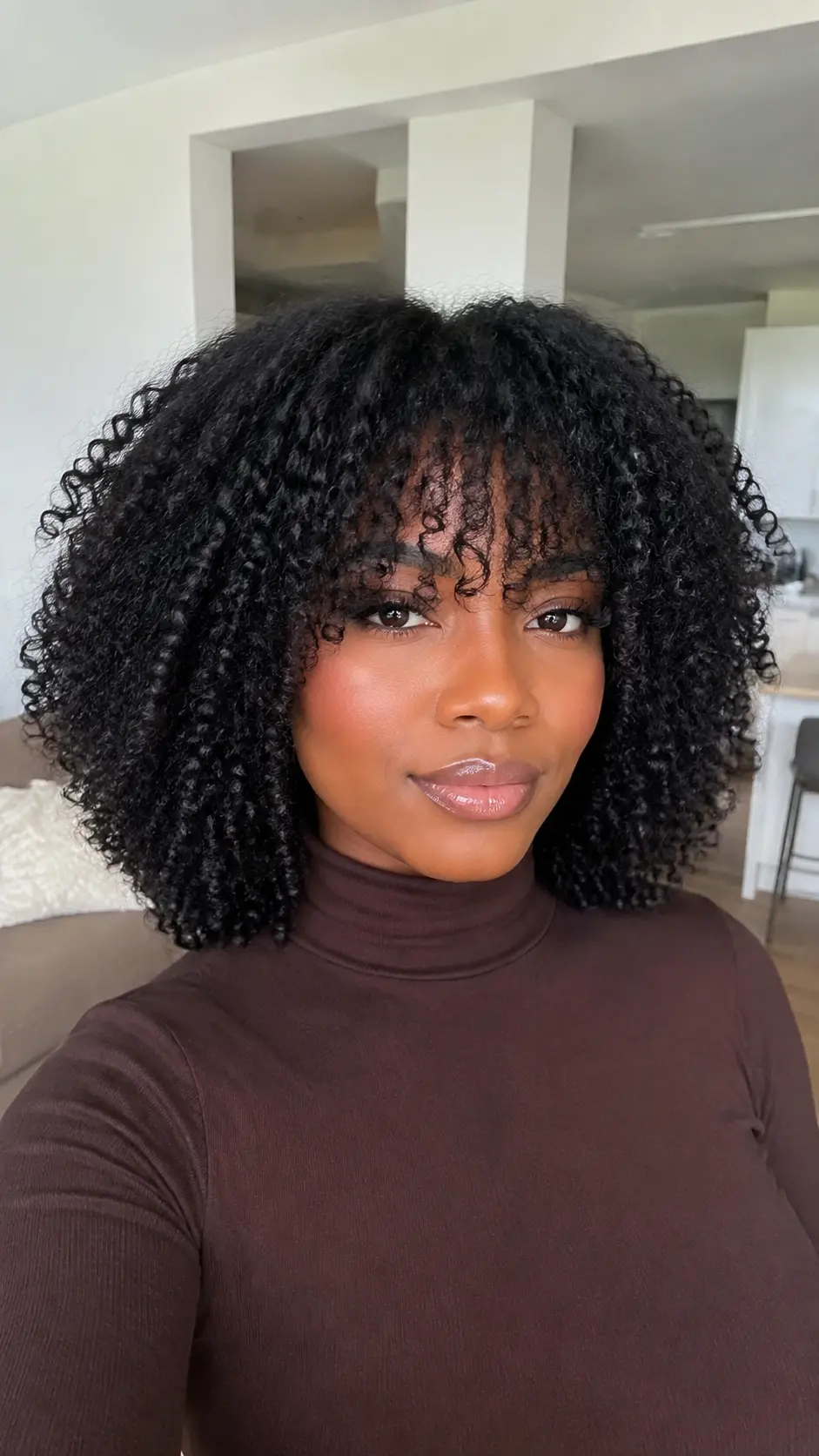 Natural shoulder length spiral curls with bangs