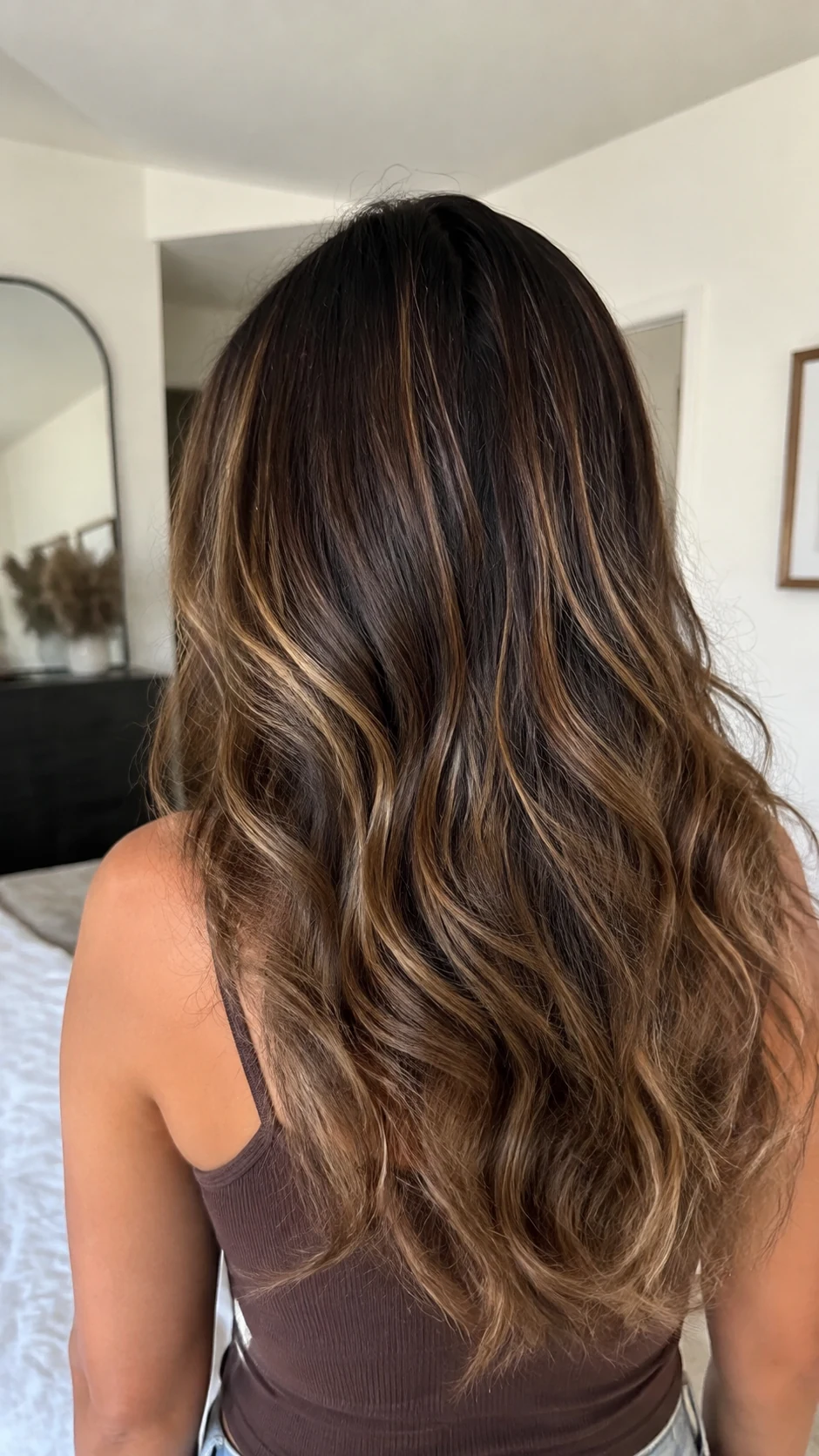 Caramel balayage brown hair with dark brunette roots