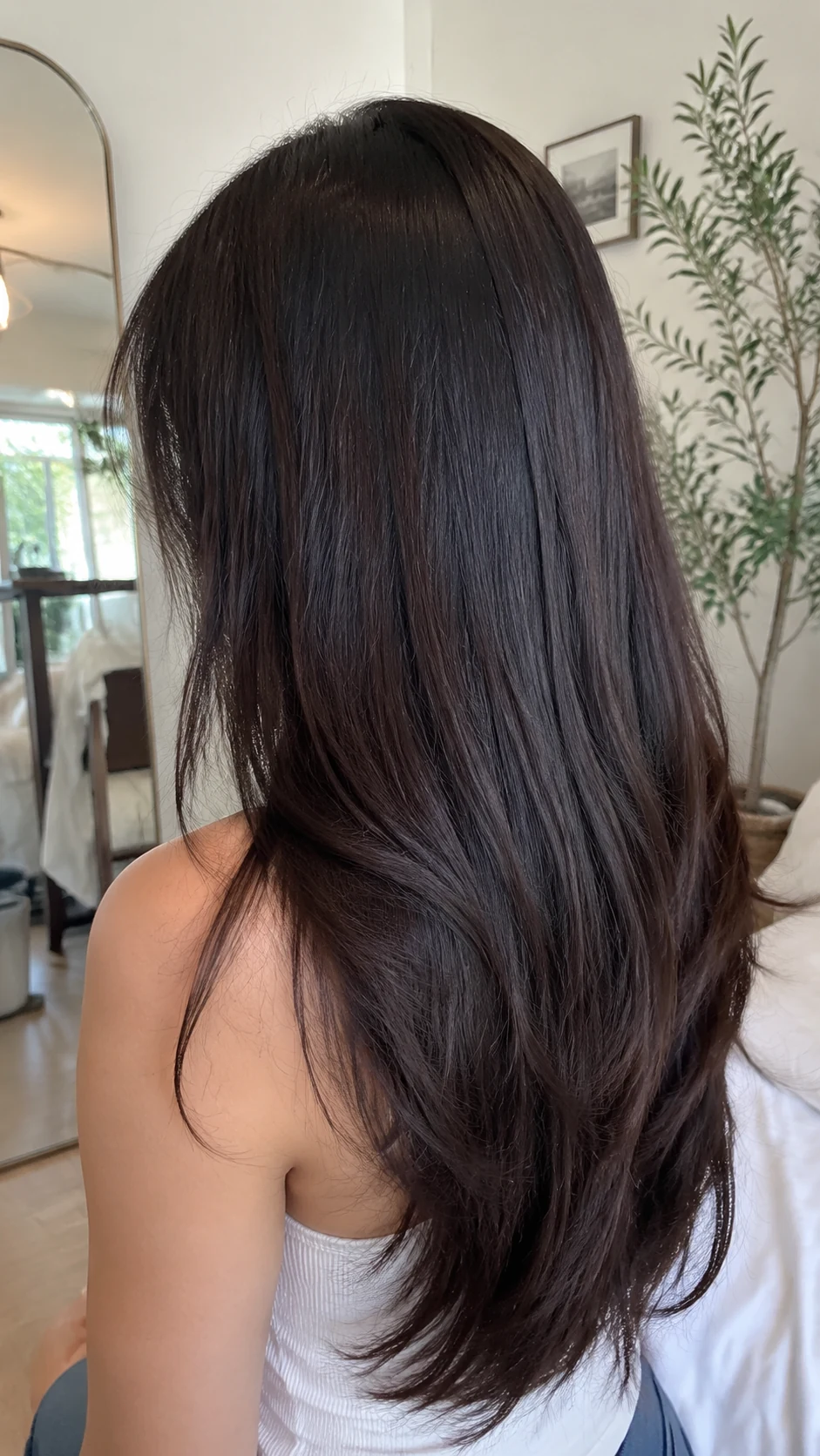Deep espresso brown hair color with sleek long layers
