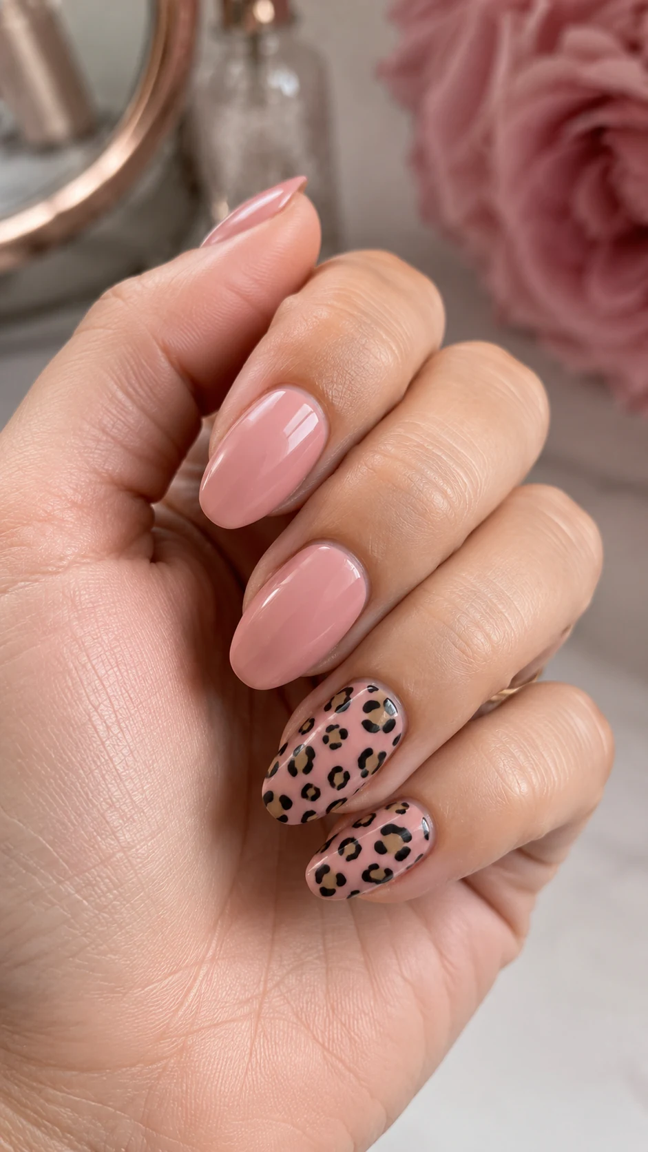 Blush pink nails with black and tan cheetah print accents