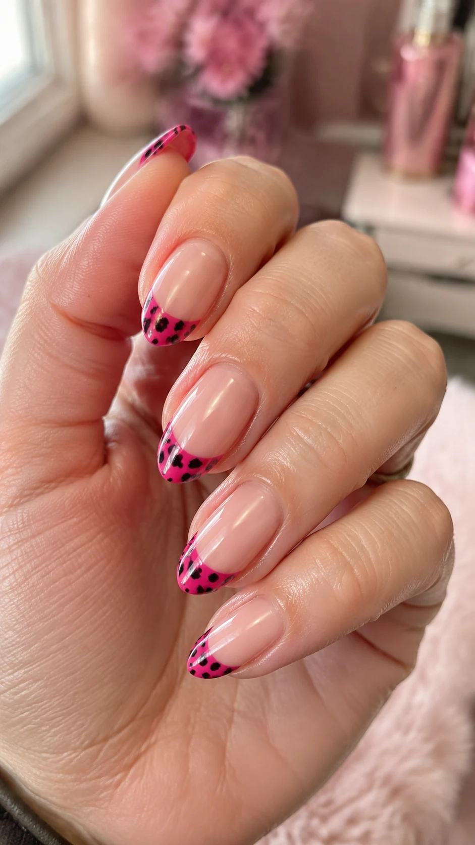 Hot pink French nails with bold black cheetah print tips