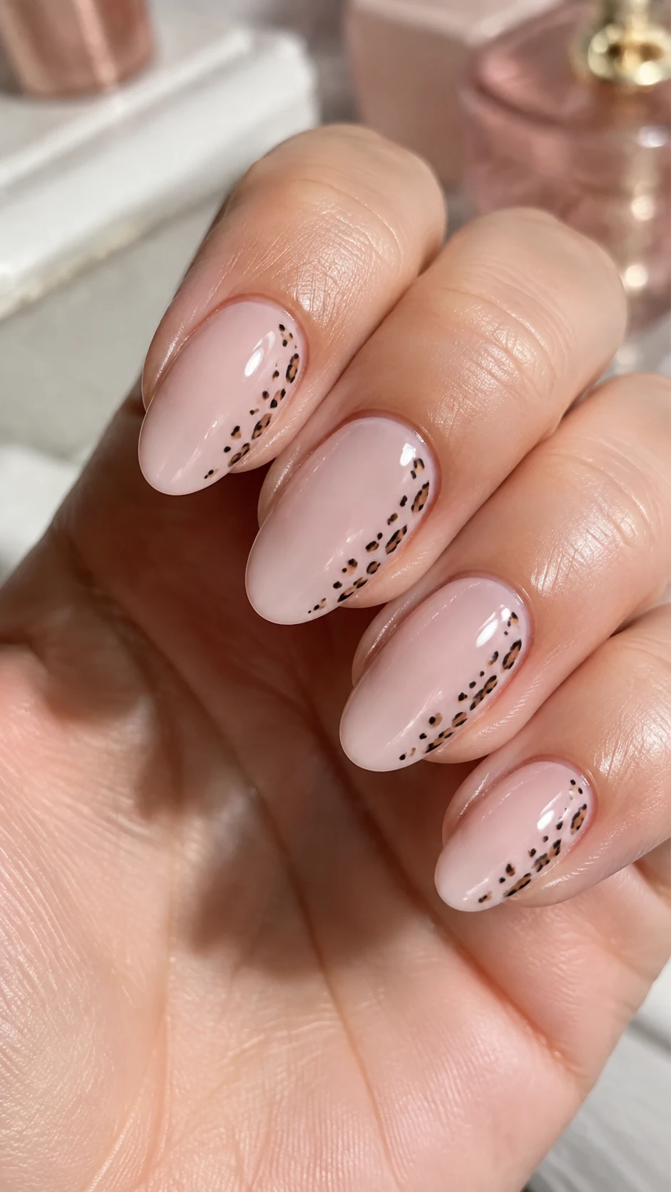 Milky pink nails with minimalist side cheetah spots