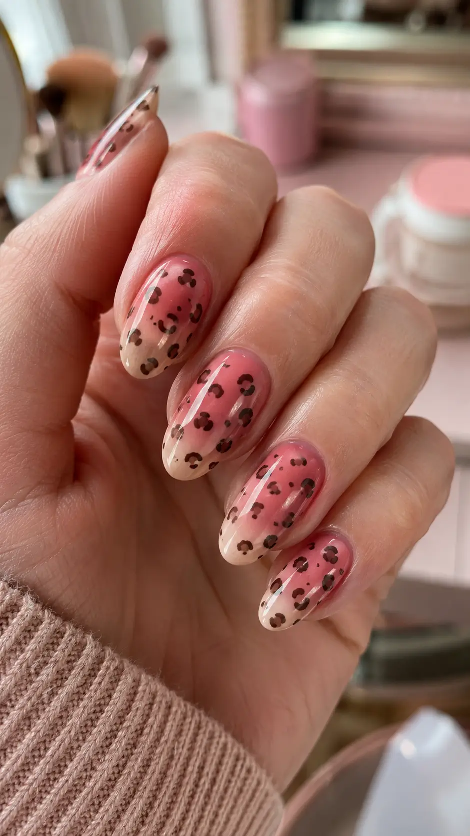 Rose pink ombre nails with scattered cheetah spots