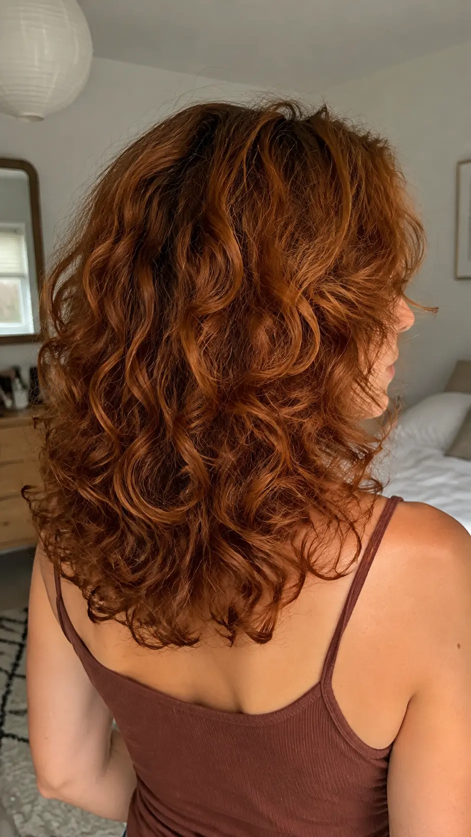 Copper curly butterfly haircut with medium rounded layers