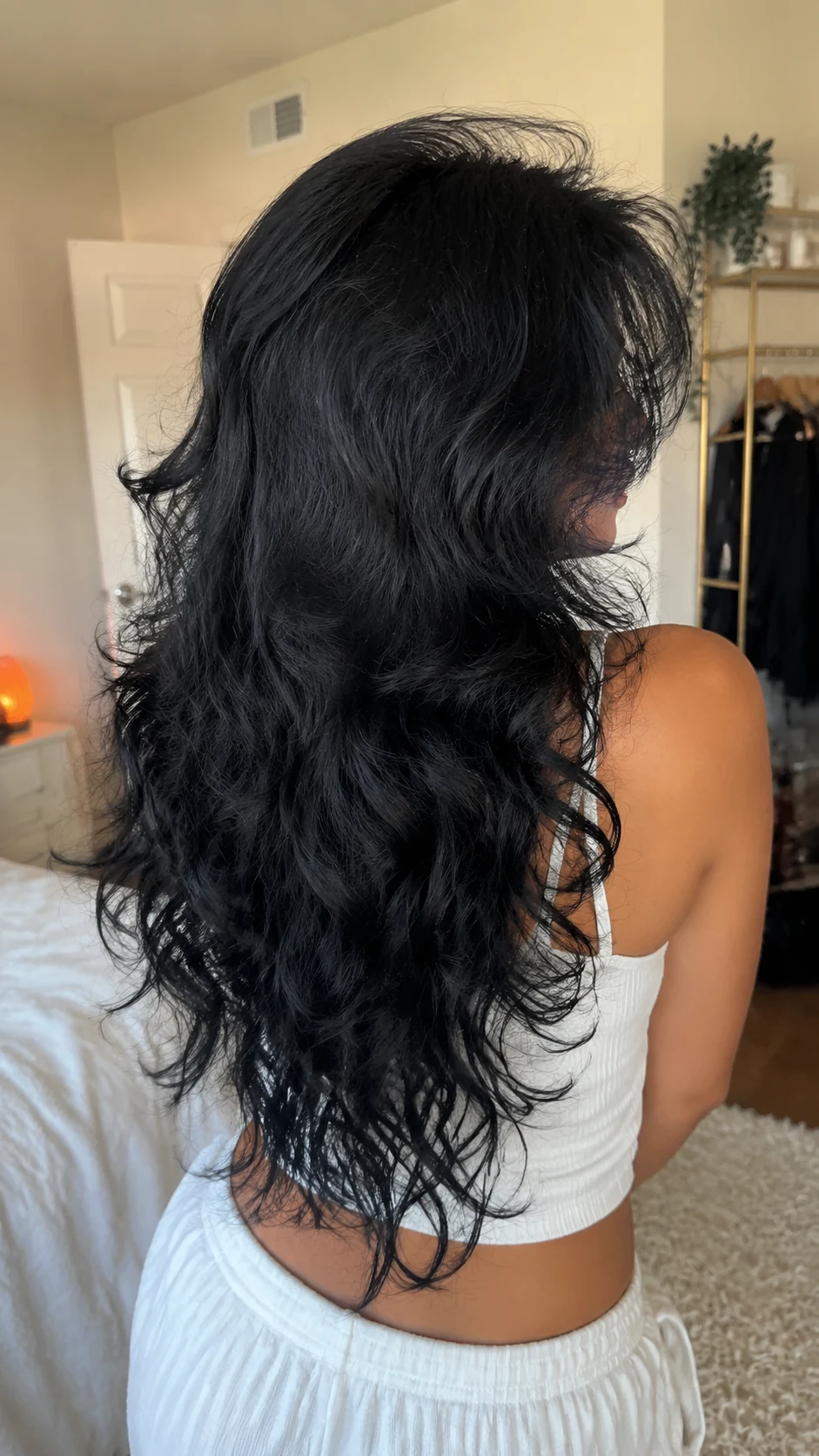 Long black curly butterfly haircut with curtain layers