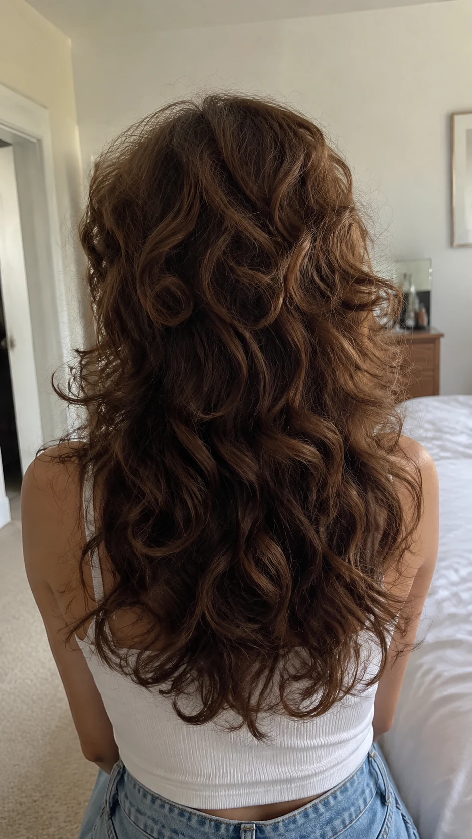 Curly shag butterfly haircut with airy brunette crown layers