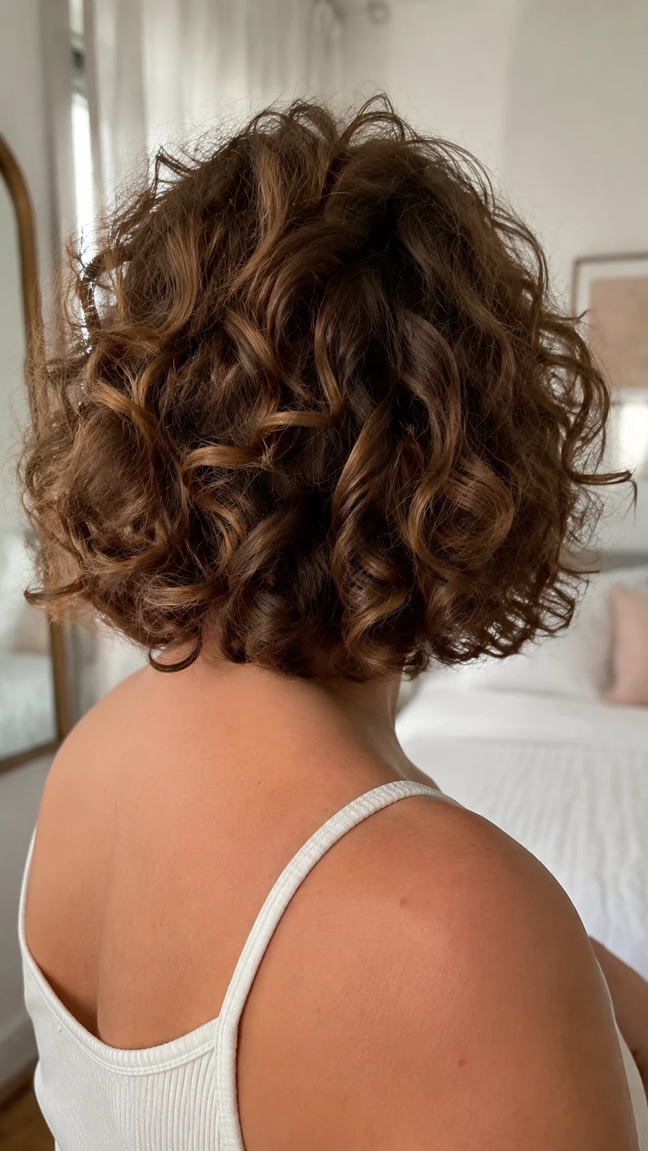 Short brown curly butterfly bob with rounded ringlets