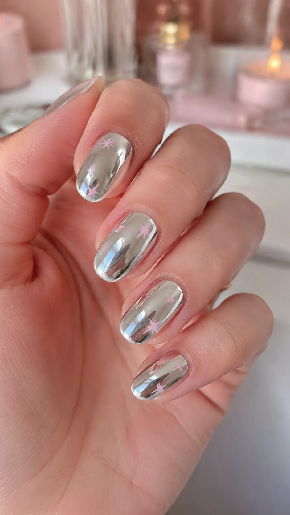 Glossy silver chrome simple Y2K nails with tiny pink stars