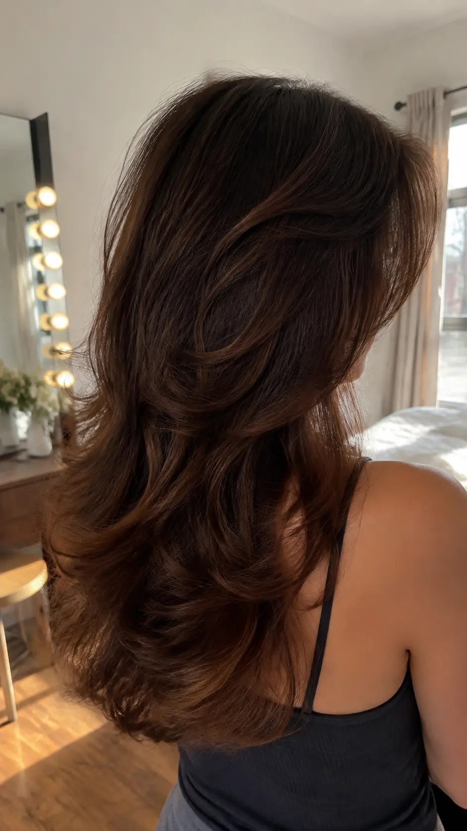 Wavy chestnut brown soft butterfly haircut with broad layers
