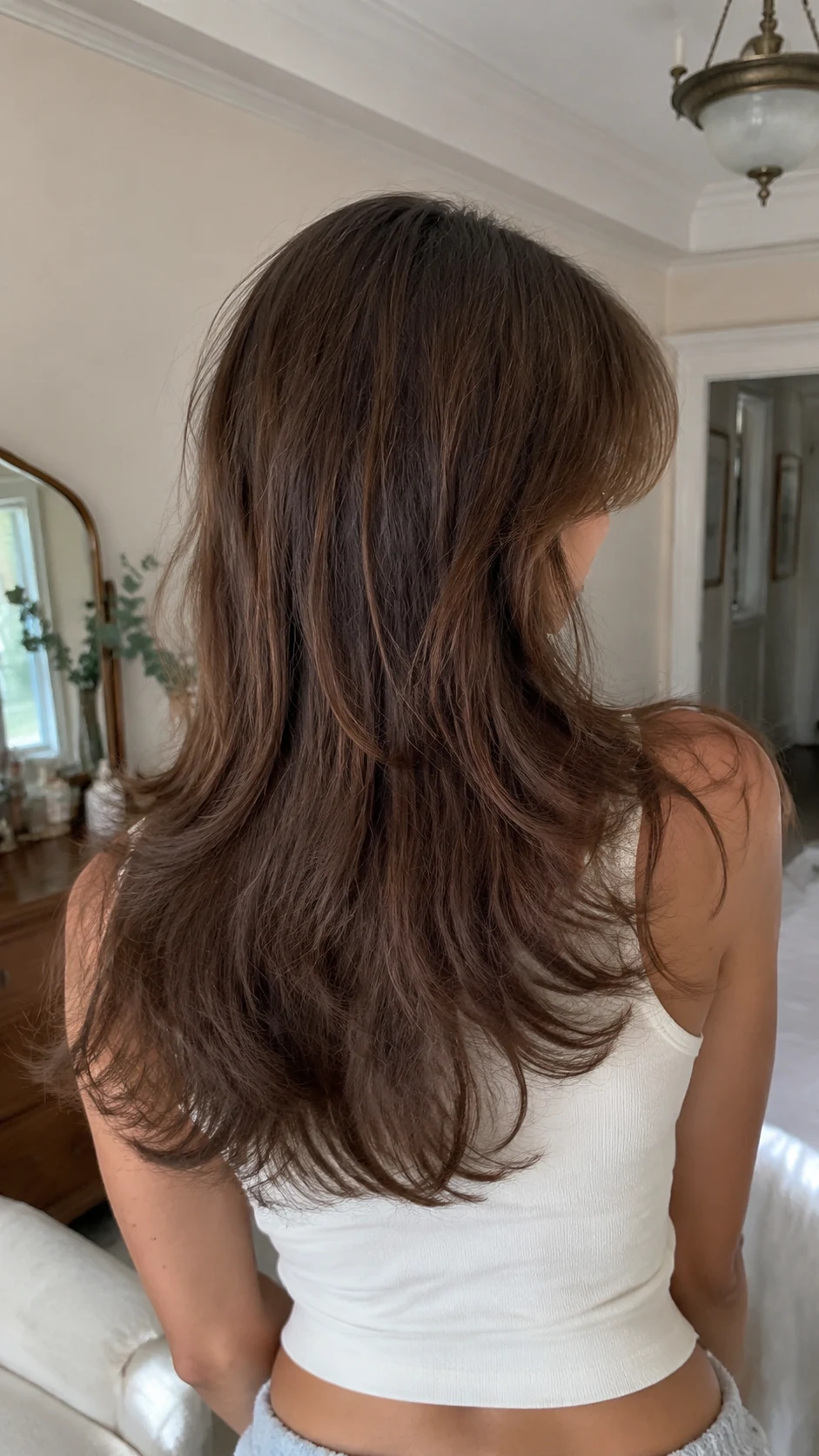 Chestnut soft butterfly haircut with wispy bangs